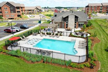Two heated outdoor pools with grilling station, sun deck & pergola