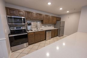 Weston apartment for rent - a kitchen with wooden cabinets and a white counter top