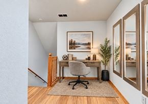 West Allis townhouse for rent - A room with a desk, chair, and a painting on the wall.