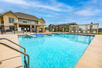 Two heated outdoor pools with grilling station, sun deck & pergola