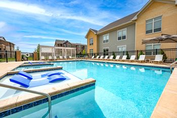 Two heated outdoor pools with grilling station, sun deck & pergola