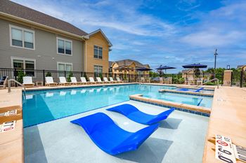 Two heated outdoor pools with grilling station, sun deck & pergola