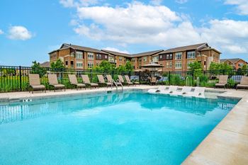 Two heated outdoor pools with grilling station, sun deck & pergola