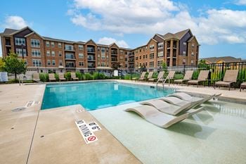 Two heated outdoor pools with grilling station, sun deck & pergola