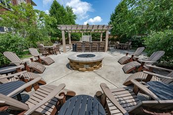 Outdoor patio with fire pit, grilling station, and food preparation area