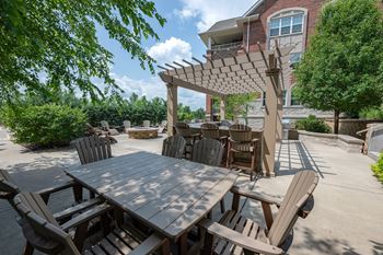Outdoor patio with fire pit, grilling station, and food preparation area
