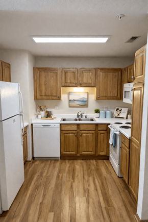 New Berlin apartment for rent - A kitchen with wooden cabinets and white appliances.