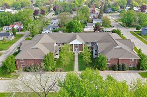 Winneconne apartment for rent - A large house with a driveway in front.