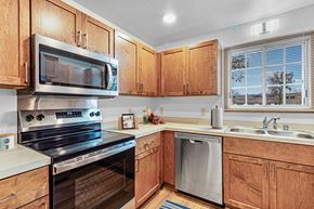 West Allis townhouse for rent - A kitchen with wooden cabinets and stainless steel appliances.