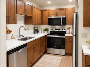 New Berlin apartment for rent - A modern kitchen with wooden cabinets and stainless steel appliances.