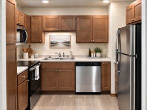 New Berlin apartment for rent - A kitchen with wooden cabinets and stainless steel appliances.
