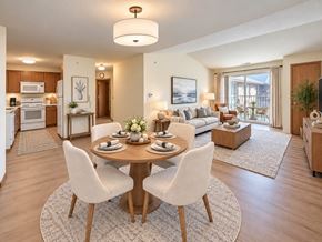 New Berlin apartment for rent - A modern dining room with a wooden table and white chairs.