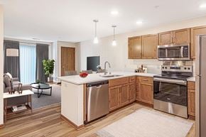 Waukesha apartment for rent - A modern kitchen with wooden cabinets and stainless steel appliances.