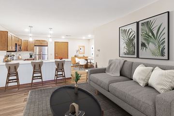 Waukesha apartment for rent - A living room with a grey couch and a black coffee table.
