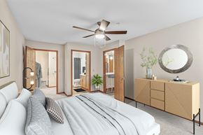 Waukesha apartment for rent - A bedroom with a large bed and a mirror on the wall.