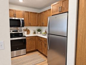 Menomonee Falls apartment for rent - A kitchen with a refrigerator, oven, and microwave.