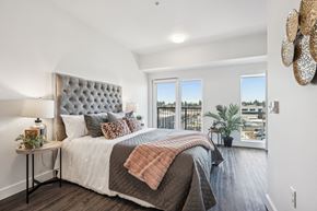 Portland apartment for rent - Bedroom with a bed and a large window at AVIVA Apartments in Gresham Oregon