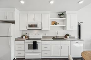 Portland apartment for rent - White kitchen with white appliances and white cabinets at AVIVA Apartments in Gresham Oregon