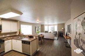 Portland apartment for rent - A kitchen with white cabinets and a wooden island.