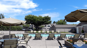 Portland apartment for rent - a swimming pool with chairs and umbrellas on a patio