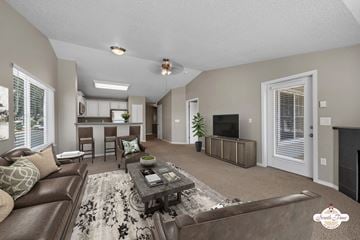 Portland apartment for rent - A living room with a brown leather couch and a fireplace.