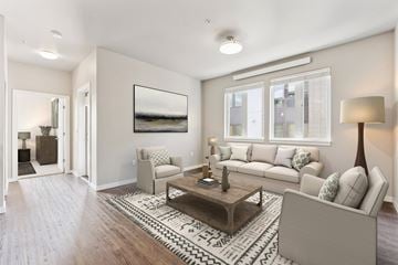 Beaverton apartment for rent - A living room with a couch, coffee table, and a painting on the wall.