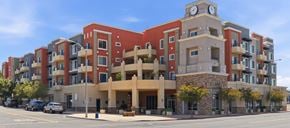Escondido apartment for rent - A large apartment building with a clock tower on the top floor.