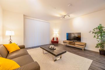 Los Angeles apartment for rent - a living room with a couch and a coffee table and a television