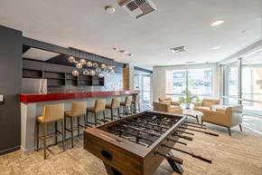 Los Angeles apartment for rent - a clubhouse with a foosball table and a bar with chairs