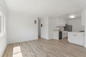 Pasadena apartment for rent - A kitchen with white cabinets and a wooden floor.