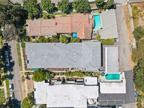 Pasadena apartment for rent - A large grey building with a pool in the middle of it.