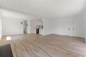 Pasadena apartment for rent - A spacious room with wooden flooring and white walls.