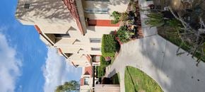 Lake Elsinore apartment for rent - Garden lined apartment walkway at Sierra Vista Apartment Homes in Lake Elsinore, California.
