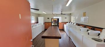Lake Elsinore apartment for rent - a kitchen with white appliances and a long wooden table