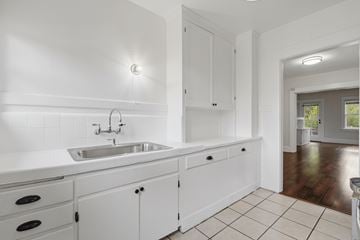 Pasadena apartment for rent - A white kitchen with a sink and cabinets.
