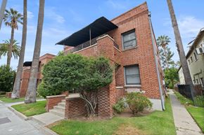 Pasadena apartment for rent - A red brick house with a tree in front.