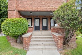 Pasadena apartment for rent - A red brick house with a black front door and steps leading to the entrance.