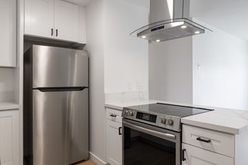Lemon Grove apartment for rent - A modern kitchen with a stainless steel refrigerator and oven.