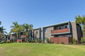 Lemon Grove apartment for rent - A modern building with balconies and a green lawn in front.