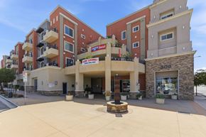 Escondido apartment for rent - A building with a red and beige facade has a sign that reads "Megastar".