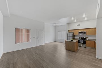 Escondido apartment for rent - A spacious kitchen and living room with wooden floors and white walls.