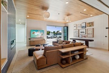 San Diego apartment for rent - A living room with a brown couch and a painting of a beach scene on the wall.