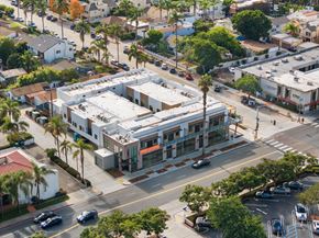 La Jolla apartment for rent - A street view of a residential area with a building in the center.