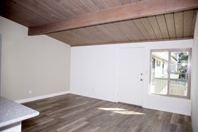 San Diego apartment for rent - Front room with hardwood floor and exposed wood ceiling at Harbor Villa Apartments in San Diego, California.
