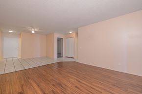 San Diego apartment for rent - Empty room with wooden floors and white walls.
