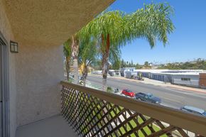 San Diego apartment for rent - A balcony with a view of a street with cars and buildings.