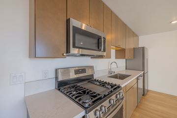 San Diego apartment for rent - A modern kitchen with a stainless steel stove and microwave.