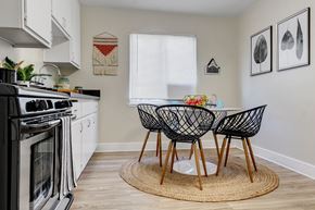 San Diego apartment for rent - a kitchen with a small table and three chairs in front of a window