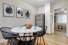 San Diego apartment for rent - a dining area with a round table with four chairs and a stainless steel refrigerator in the background