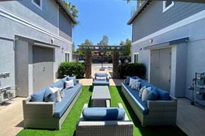 Escondido apartment for rent - Community patio with couches at the Nines Townhomes in Escondido, California.